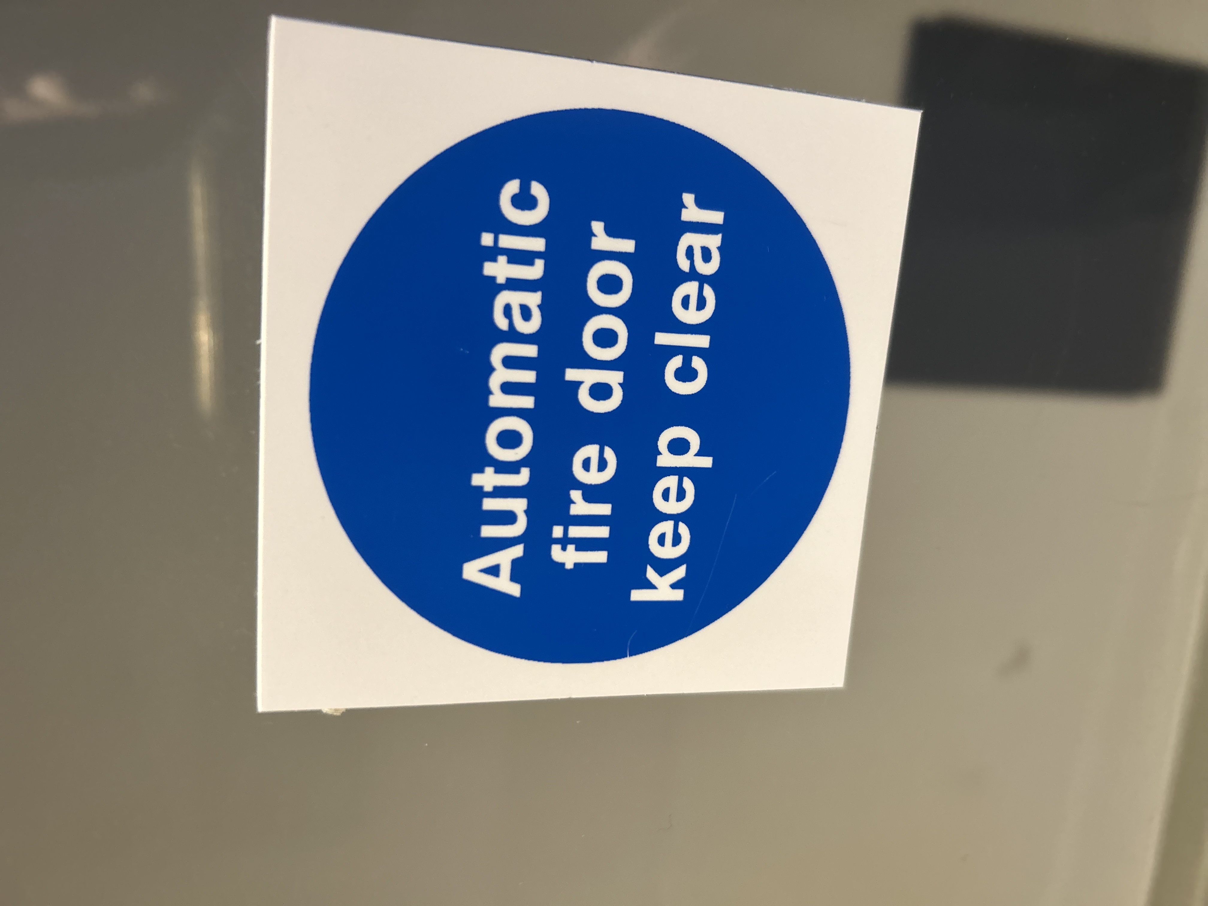 Automatic fire door keep clear sign