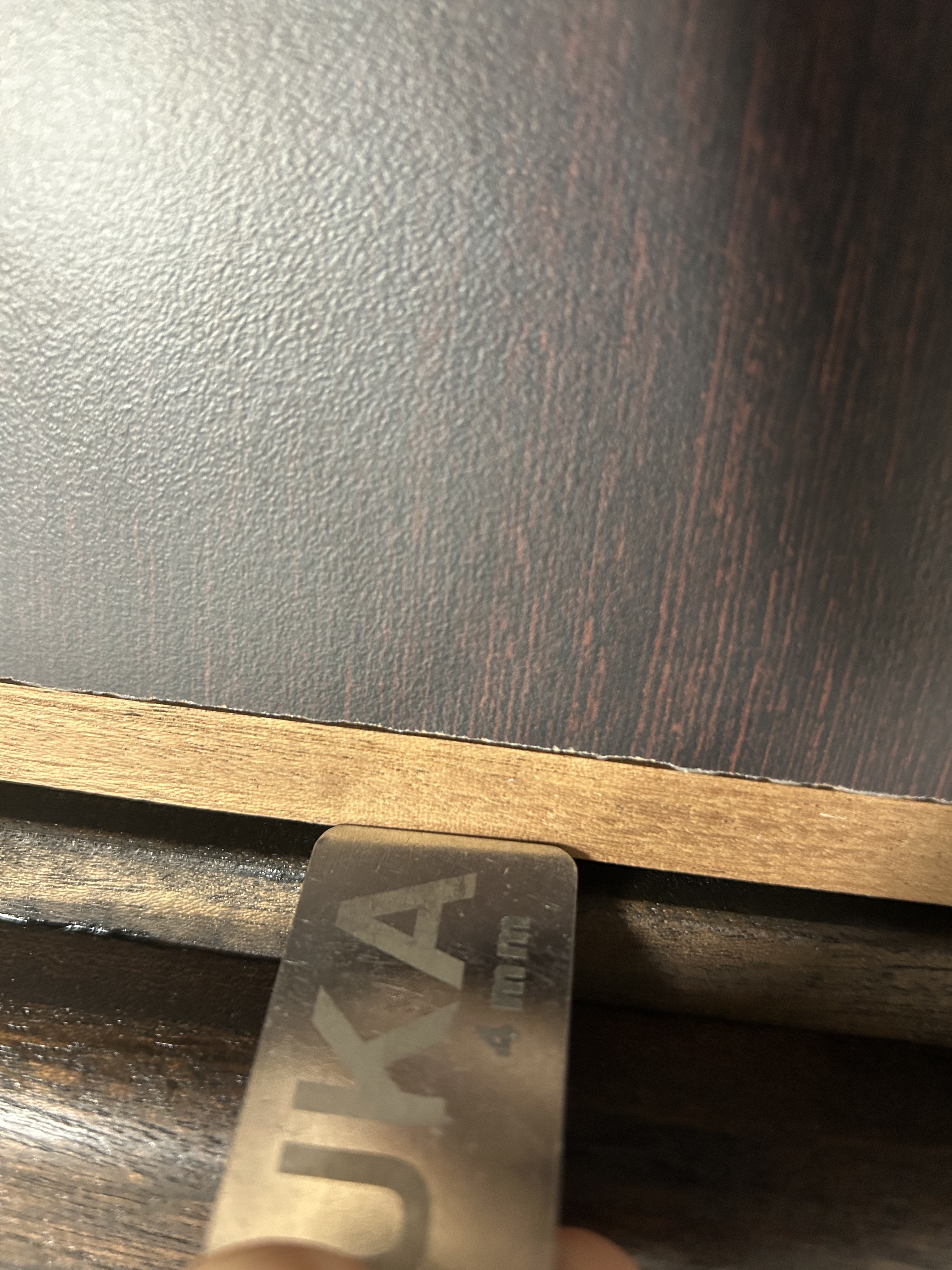 Gap gauge measuring fire door gap at door edge